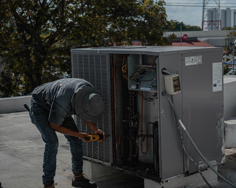 Cool Magic Ventures technician servicing HVAC unit
